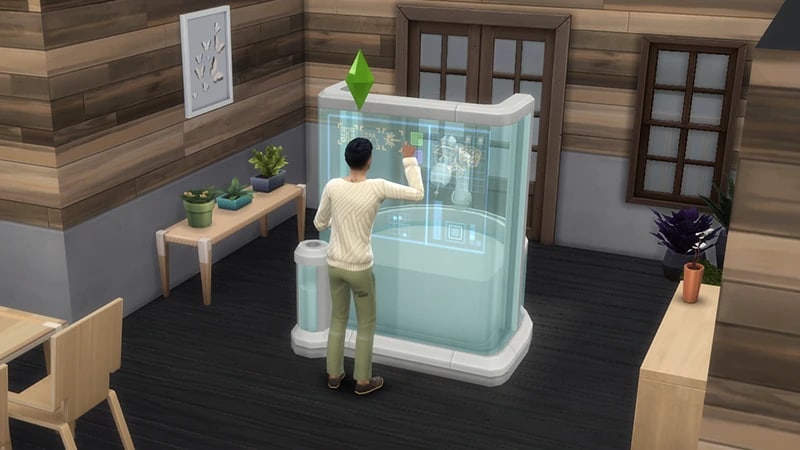 A Sim stands in front of the Fabricator using the digital panel on the front to fabricate something inside the machine.