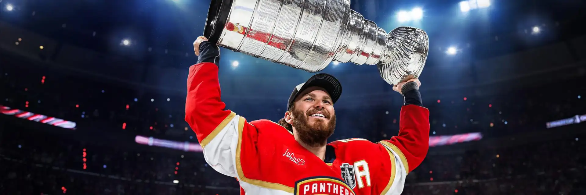Florida Panthers forward, Matthew Tkachuk, lifts the Stanley Cup before a crowded stadium