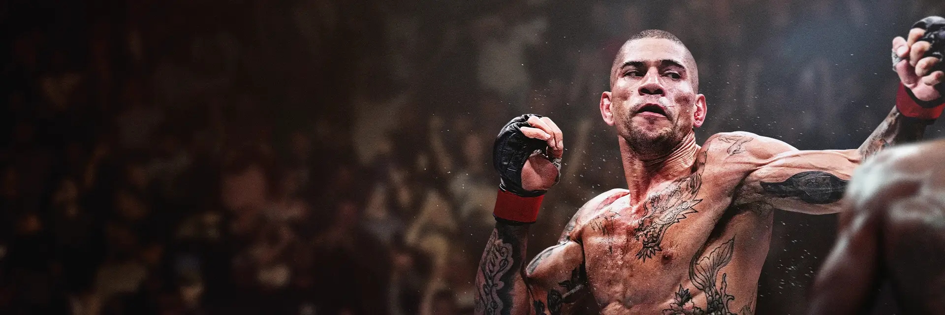 MMA fighter Alex Pereira throws a punch in the octagon, with visible sweat and a blurred crowd in the background.