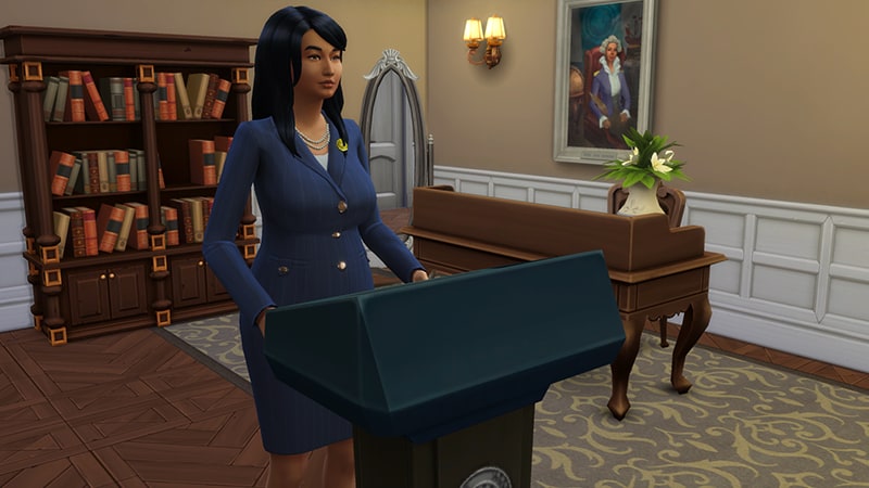 A Sim with dark hair, in a navy business suit stands at a podium in an office as she prepares to give a speech.