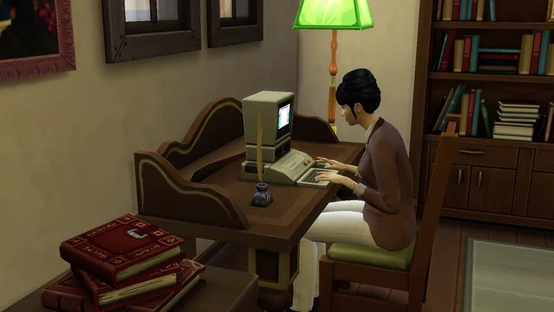 A Sim sits at a desk typing on the computer with a green lamp in the corner. On the desk sits a quill in an ink pot.