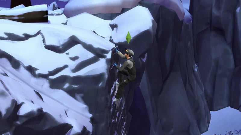 A Sim wearing a black and gray snowsuit is almost at the top of climbing the rocky side of a snowy mountain.