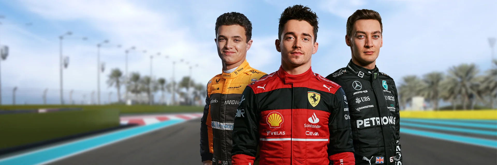 Lando Norris, Charles Leclerc, and George Russell stand in racing suits on track with a blue sky backdrop. 
