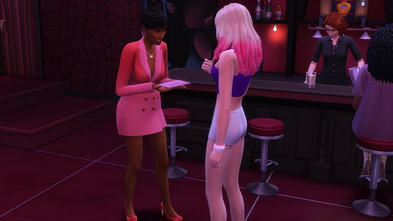 In a dimly lit bar, a Sim wearing a short pink dress is showing another Sim something on a piece of paper.