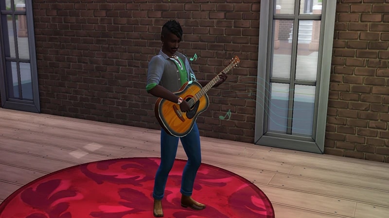 A Sim wearing a gray shirt with a green top stands in the middle of a circular red rug playing the guitar.