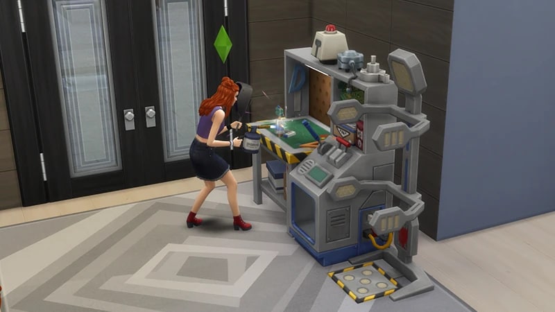 A Sim with red hair is building something at the robotics station in The Sims 4.